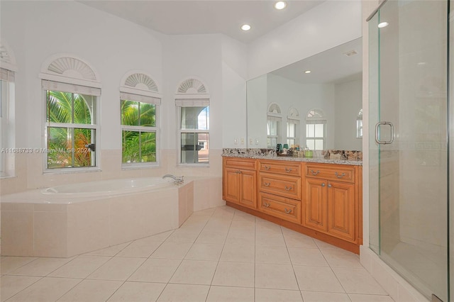 bathroom featuring tile patterned flooring, shower with separate bathtub, and vanity