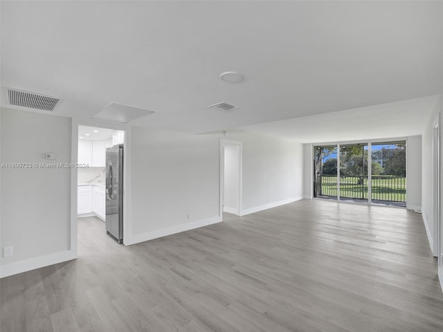 3700 Oaks Clubhouse Dr Unit 203, Pompano Beach, FL 33069 - unfurnished room with attic access, light wood-style flooring, and baseboards