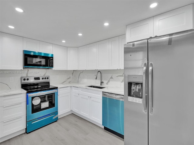 3700 Oaks Clubhouse Dr Unit 203, Pompano Beach, FL 33069 - kitchen featuring appliances with stainless steel finishes, a sink, white cabinetry, and recessed lighting