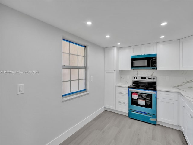 kitchen featuring white cabinetry, light hardwood / wood-style flooring, and electric stove