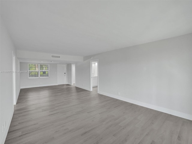 3700 Oaks Clubhouse Dr Unit 203, Pompano Beach, FL 33069 - spare room featuring wood finished floors and baseboards