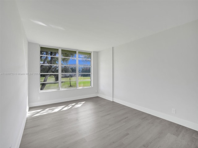 spare room with light hardwood / wood-style flooring