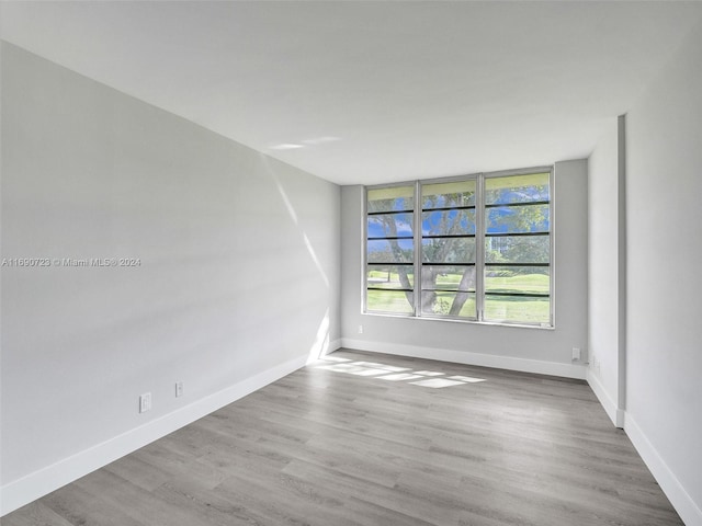 3700 Oaks Clubhouse Dr Unit 203, Pompano Beach, FL 33069 - unfurnished room featuring wood finished floors and baseboards