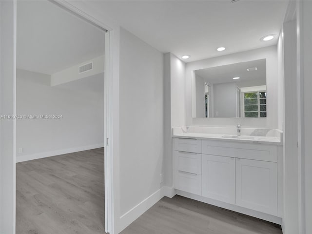 3700 Oaks Clubhouse Dr Unit 203, Pompano Beach, FL 33069 - bathroom with wood finished floors, baseboards, vanity, and recessed lighting