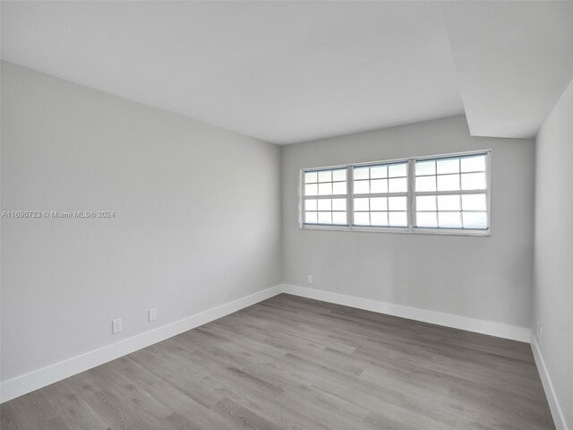 3700 Oaks Clubhouse Dr Unit 203, Pompano Beach, FL 33069 - empty room with wood finished floors and baseboards