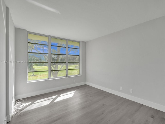 3700 Oaks Clubhouse Dr Unit 203, Pompano Beach, FL 33069 - spare room featuring wood finished floors and baseboards