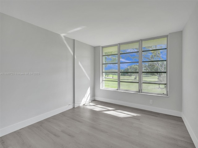 3700 Oaks Clubhouse Dr Unit 203, Pompano Beach, FL 33069 - unfurnished room with wood finished floors and baseboards