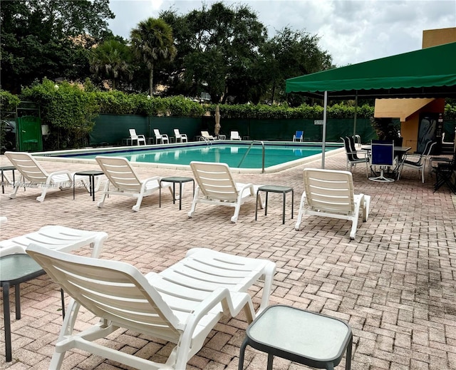 view of swimming pool with a patio area