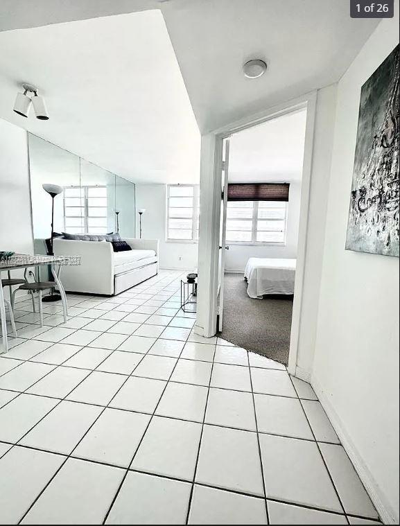 corridor with light tile patterned flooring