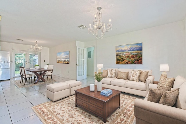 living room with french doors, light tile patterned floors, and a chandelier