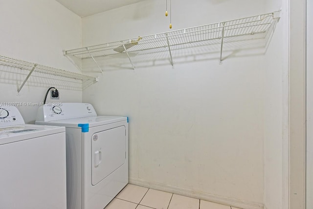 washroom with independent washer and dryer and light tile patterned floors