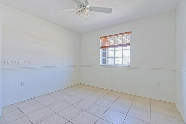 tiled spare room featuring ceiling fan and a textured ceiling