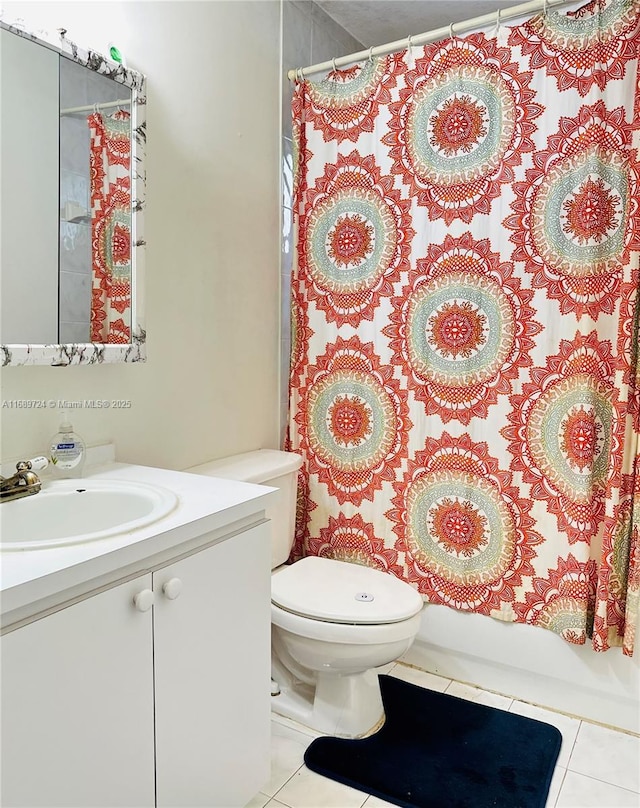 full bathroom with tile patterned flooring, shower / tub combo, vanity, and toilet