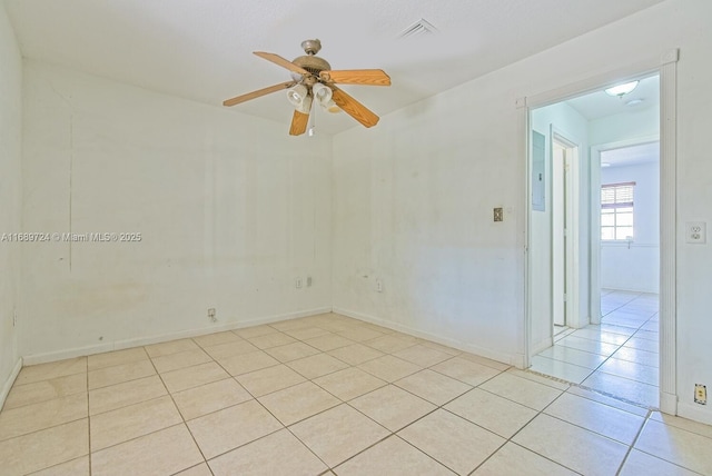 tiled empty room featuring ceiling fan