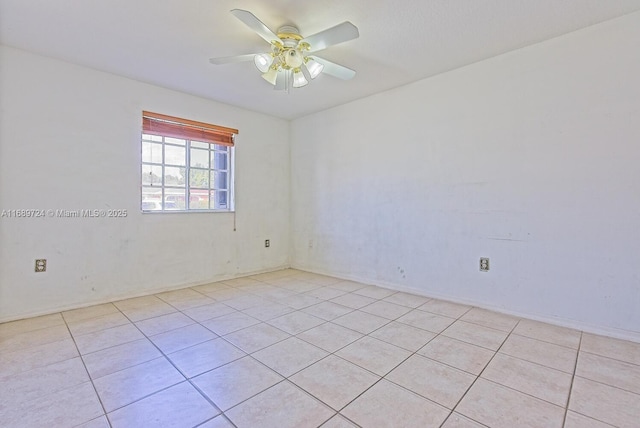 spare room featuring ceiling fan and light tile patterned flooring