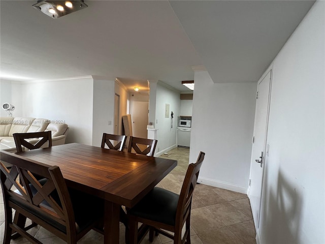 tiled dining room with crown molding