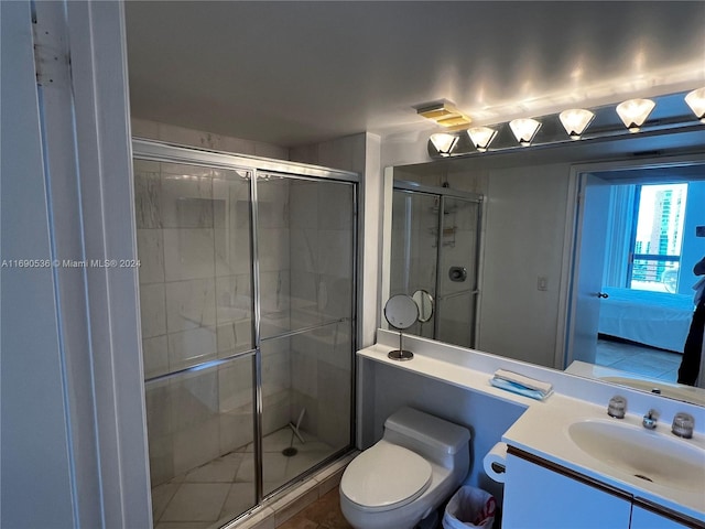 bathroom with vanity, toilet, and a shower with door