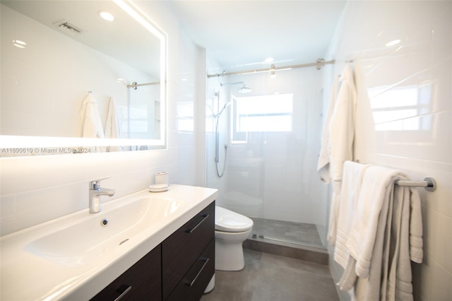 bathroom with concrete flooring, tile walls, vanity, an enclosed shower, and toilet