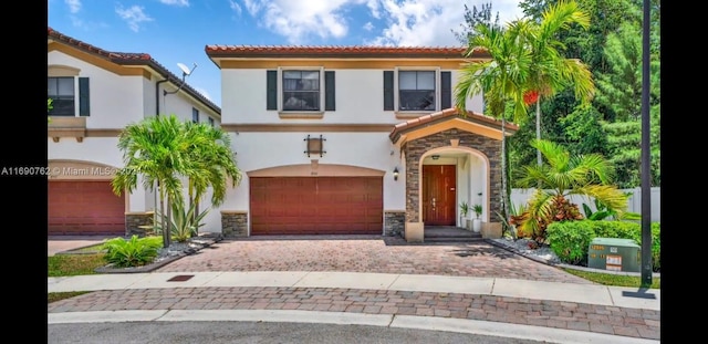 mediterranean / spanish home featuring a garage