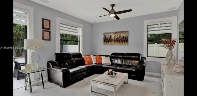 living room with a wealth of natural light and ceiling fan