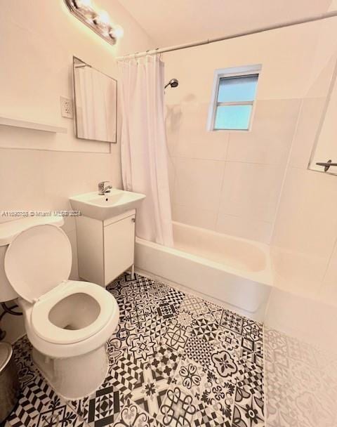 full bathroom with toilet, vanity, shower / bath combination with curtain, and tile patterned floors