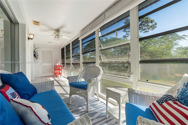 sunroom / solarium featuring ceiling fan