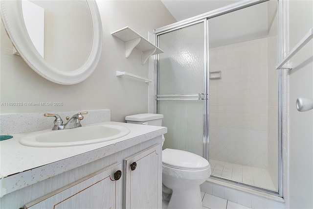 bathroom featuring vanity, an enclosed shower, and toilet