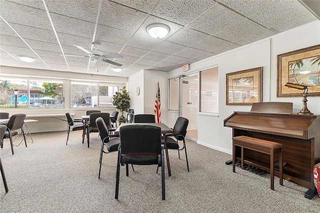 carpeted dining space with ceiling fan