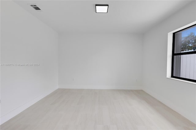 spare room with light hardwood / wood-style flooring