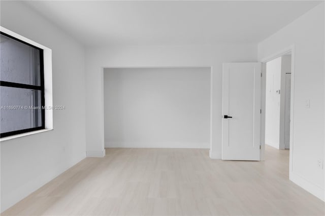 empty room with light hardwood / wood-style flooring