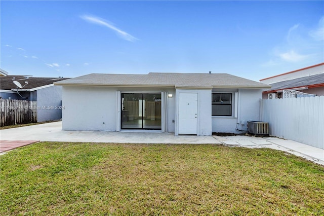 rear view of property with central AC, a yard, and a patio area