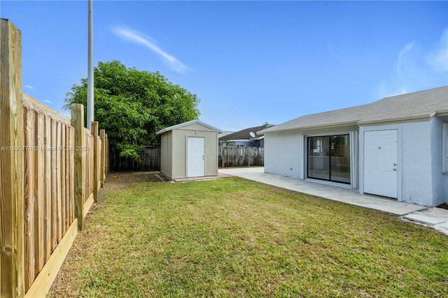 view of yard with a patio area and a storage shed