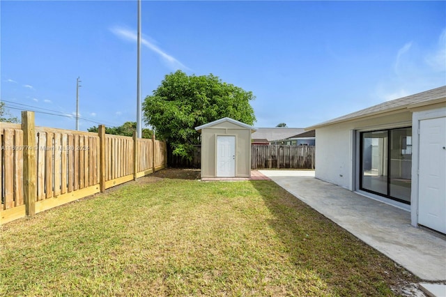 view of yard featuring a patio and a storage shed