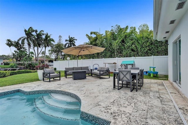 view of swimming pool featuring an outdoor living space and a patio area