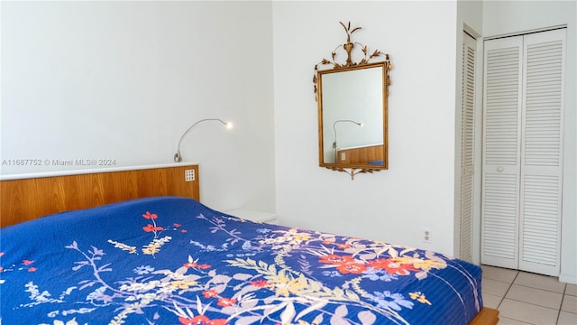 tiled bedroom featuring a closet