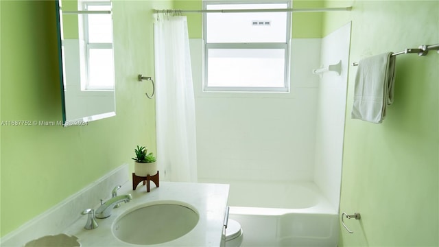 full bathroom with vanity, toilet, and shower / tub combo