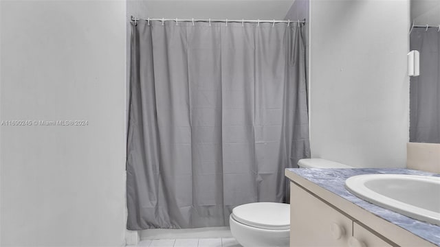 bathroom featuring tile patterned flooring, vanity, and toilet