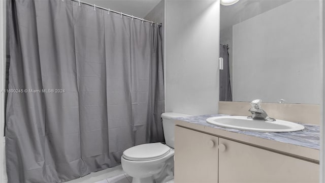 bathroom featuring toilet, vanity, tile patterned floors, and a shower with curtain