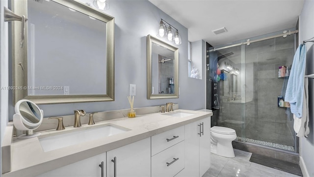 bathroom featuring toilet, vanity, an enclosed shower, and tile patterned floors