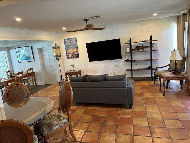 living room with tile patterned flooring and ceiling fan