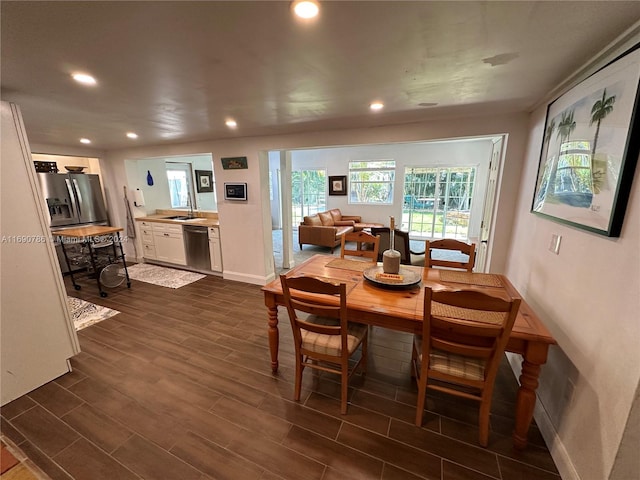 dining space with dark wood-type flooring and sink