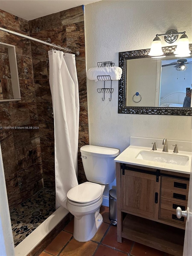 bathroom featuring curtained shower, tile patterned flooring, vanity, and toilet