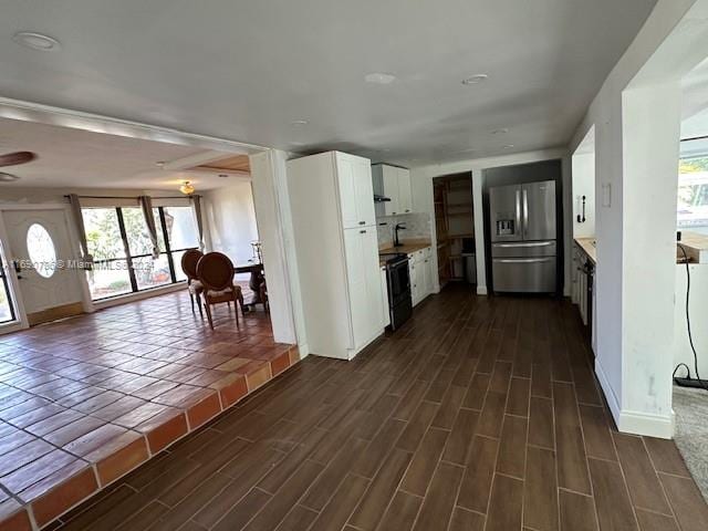 kitchen featuring white cabinets, stainless steel refrigerator with ice dispenser, dark hardwood / wood-style floors, and black electric range oven