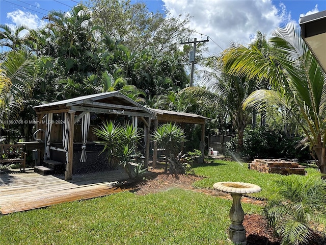 view of yard with a gazebo and a wooden deck