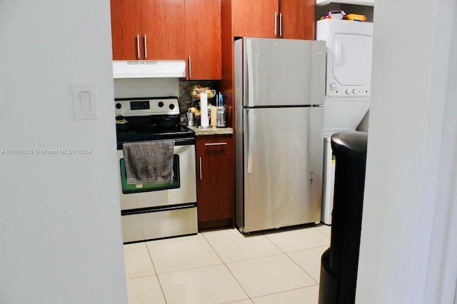 kitchen featuring stainless steel appliances, light tile patterned flooring, and backsplash