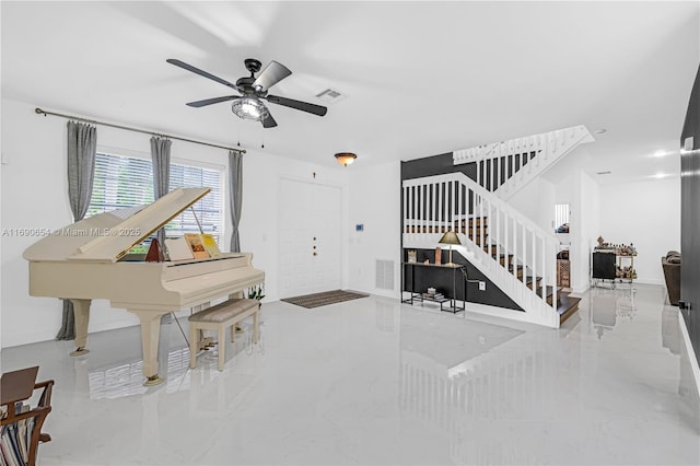 interior space featuring stairs, ceiling fan, visible vents, and baseboards