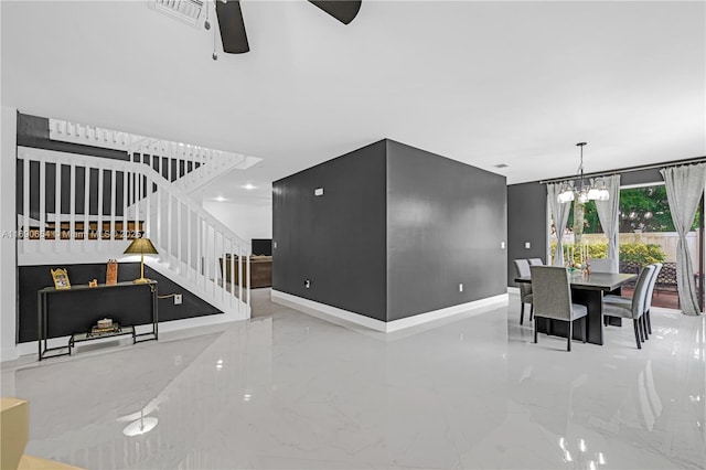 living room with ceiling fan with notable chandelier