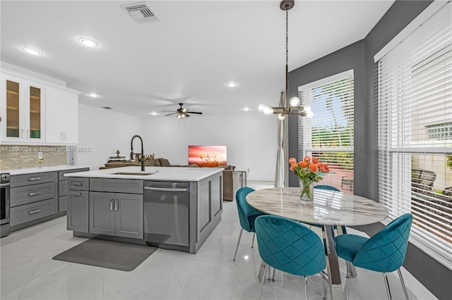 kitchen featuring dishwasher, white cabinets, sink, gray cabinets, and decorative light fixtures