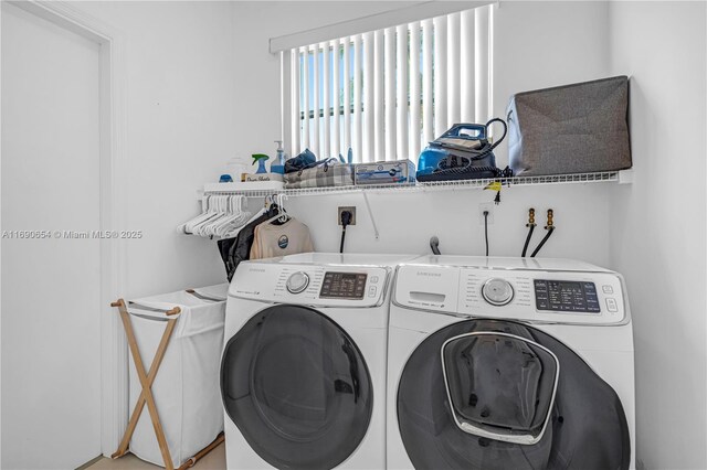 clothes washing area featuring washer and clothes dryer