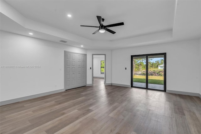 empty room featuring ceiling fan and light hardwood / wood-style flooring